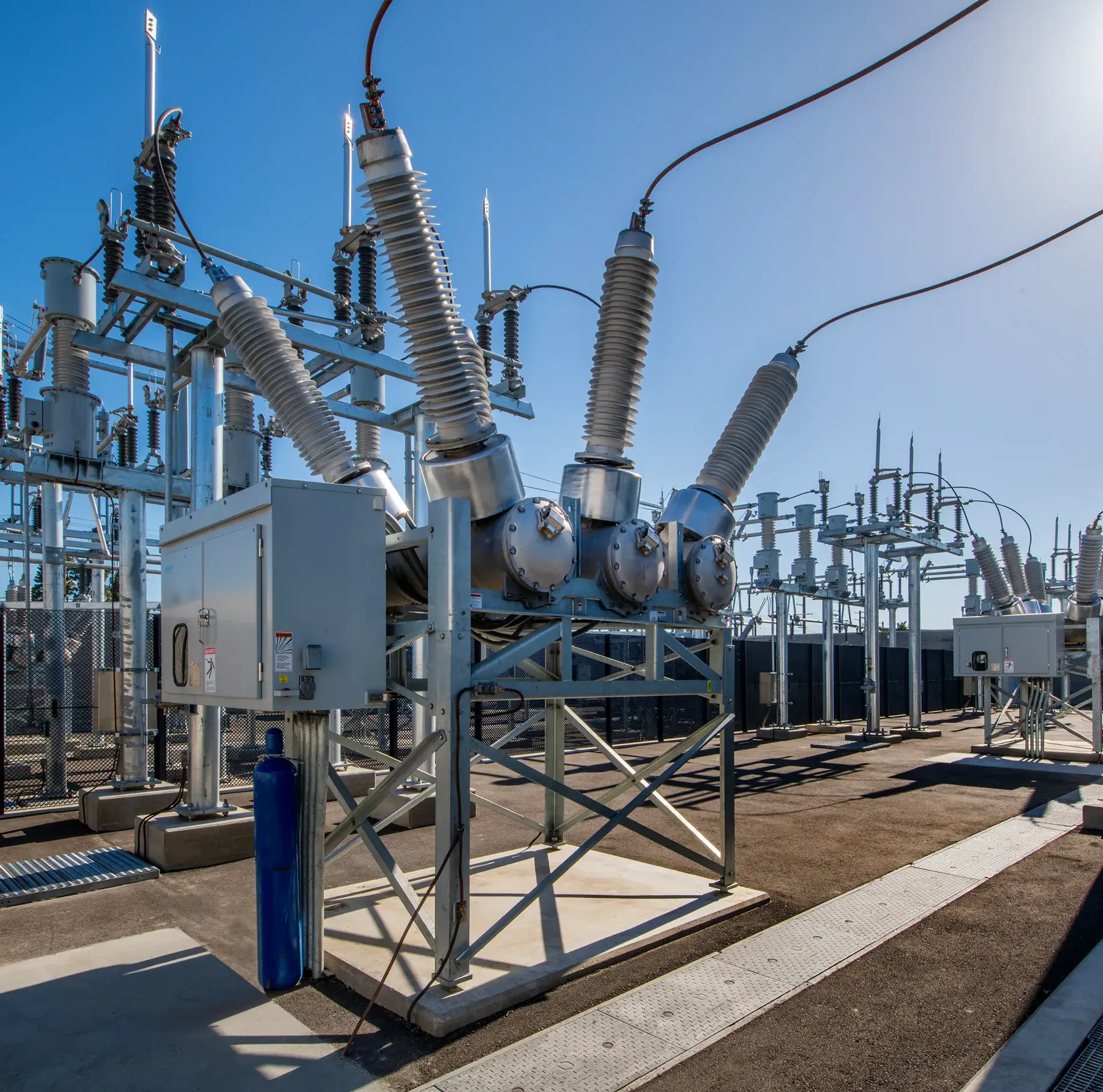 Electrical substation with power equipment outdoors.