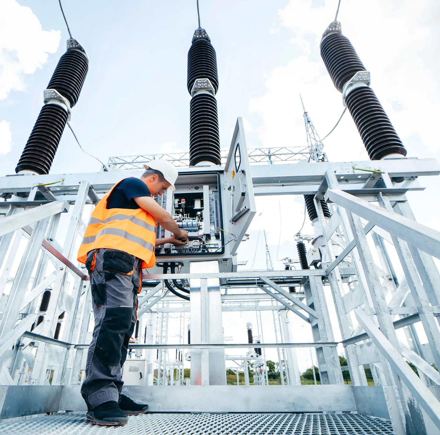 Technician working on electrical substation equipment.
